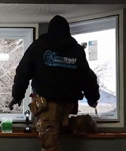 Image depicts a NorthShield Windows and Doors window installer.