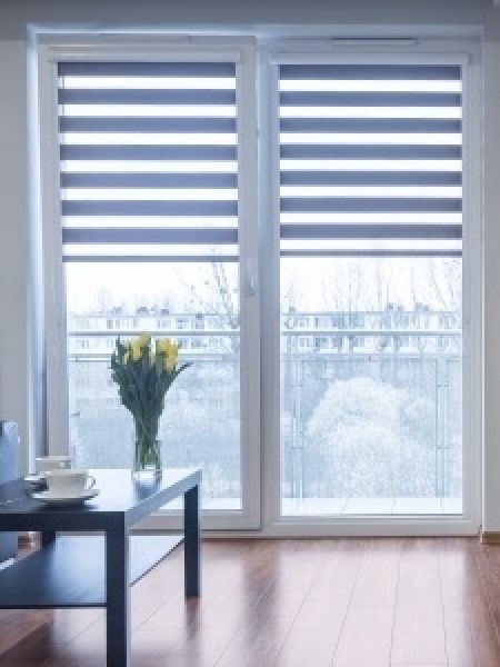 Image depicts new blinds installed on a vinyl window.