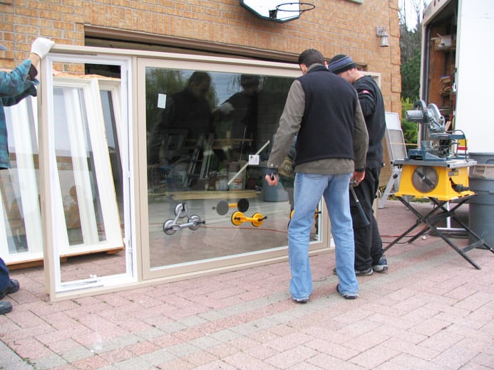 Image depicts NorthShield employees installing new windows.