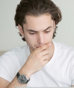 Image depicts person thinking windows and doors companies.