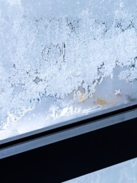 Image depicts ice build up on a window.