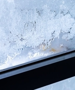 Image depicts ice build up on a window.