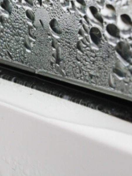 Image depicts rain on windows.