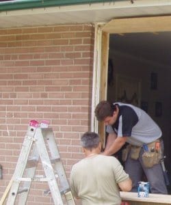 Image depicts NorthShield employees installing a new window.
