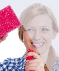 Image depicts woman cleaning a window.