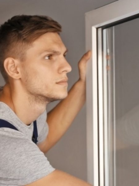 Image depicts a professional NorthShield window installer.