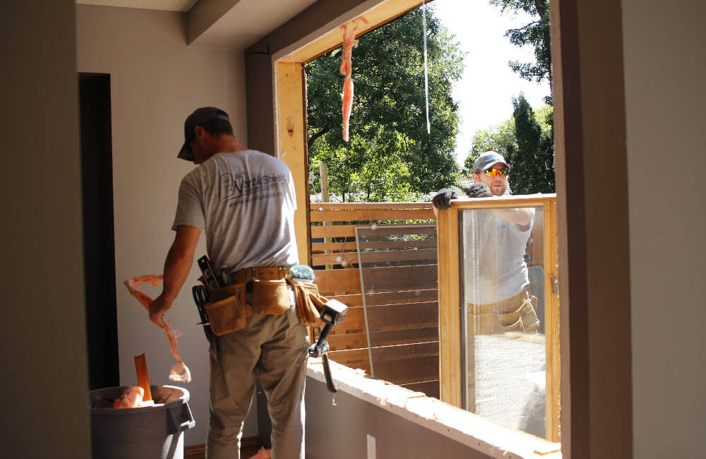 Image depicts NorthShield employees installing new windows.