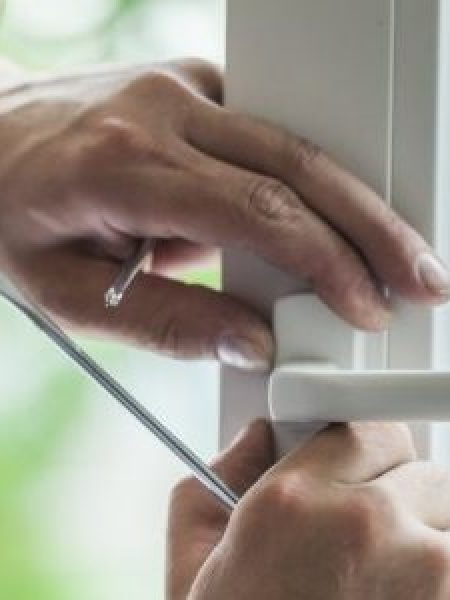 Image depicts someone replacing a window.