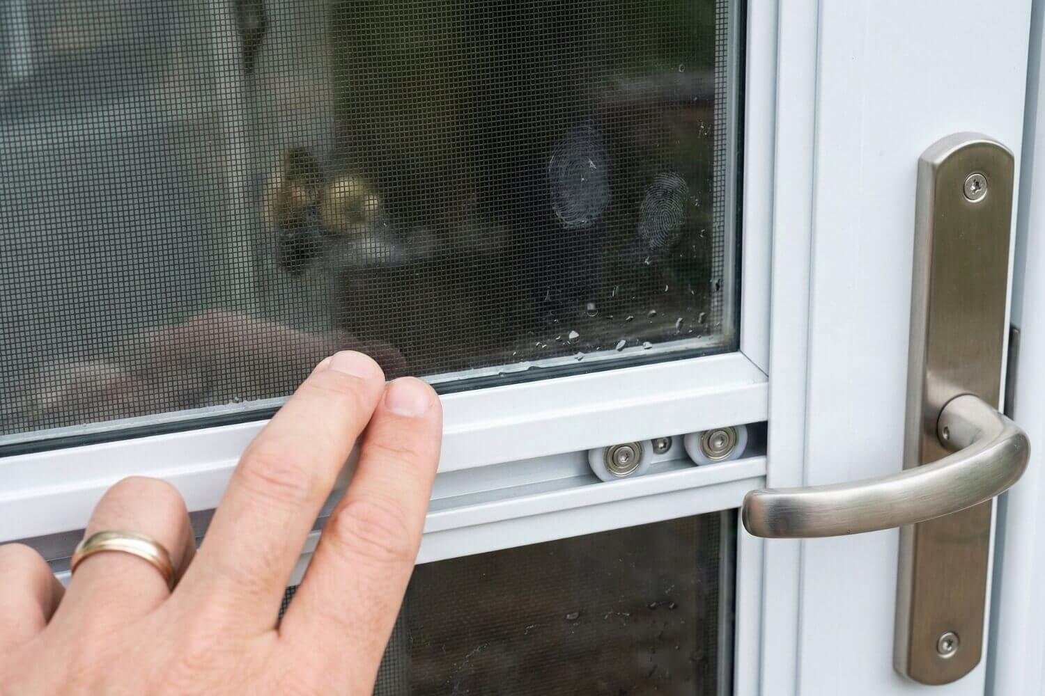 Adjusting the retractable screen on a highly functional storm door.