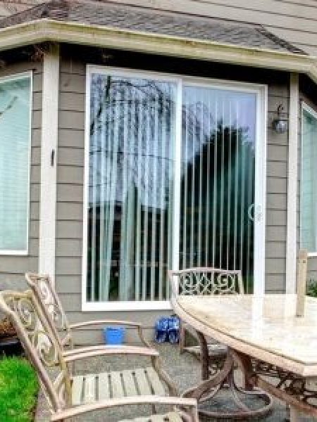 Image depicts a home with sliding patio doors.