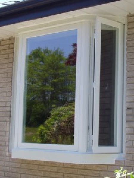 Image depicts a Winnipeg home with a bow window.