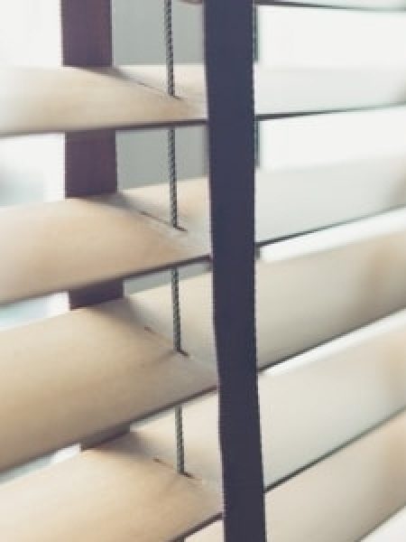 Image depicts window blinds in a home.