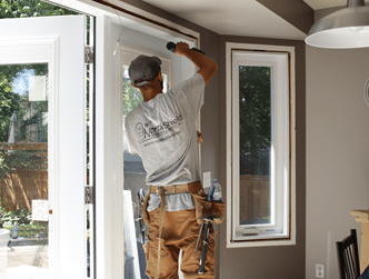 Image depicts a window replacement technician from NorthShield Windows & Doors.