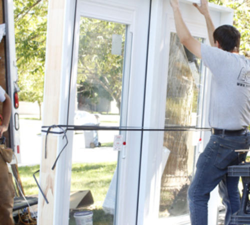 Image depicts a NorthShield employee installing a new window.