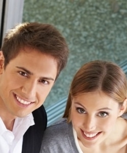 Image depicts a couple in front of their new vinyl window.