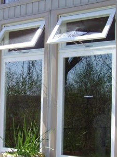 Image depicts two new vinyl windows installed in a home.