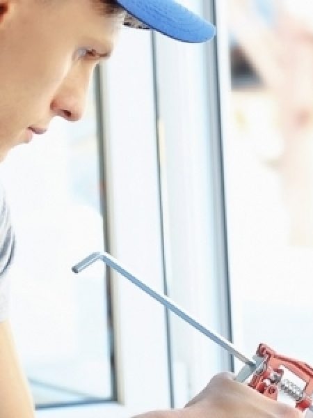 Image depicts a NorthShield employee replacing a window.