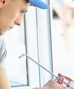 Image depicts a NorthShield employee replacing a window.