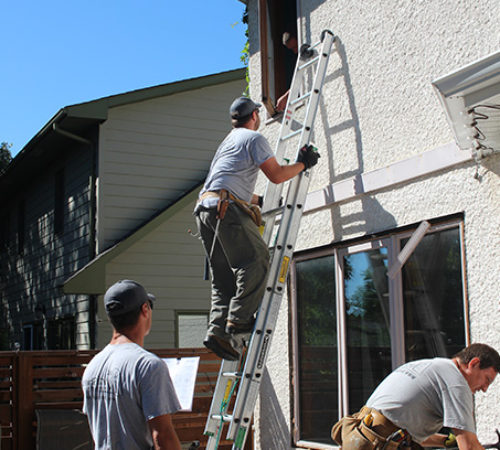 Doors and Windows Installation on a ladder in Orangeville