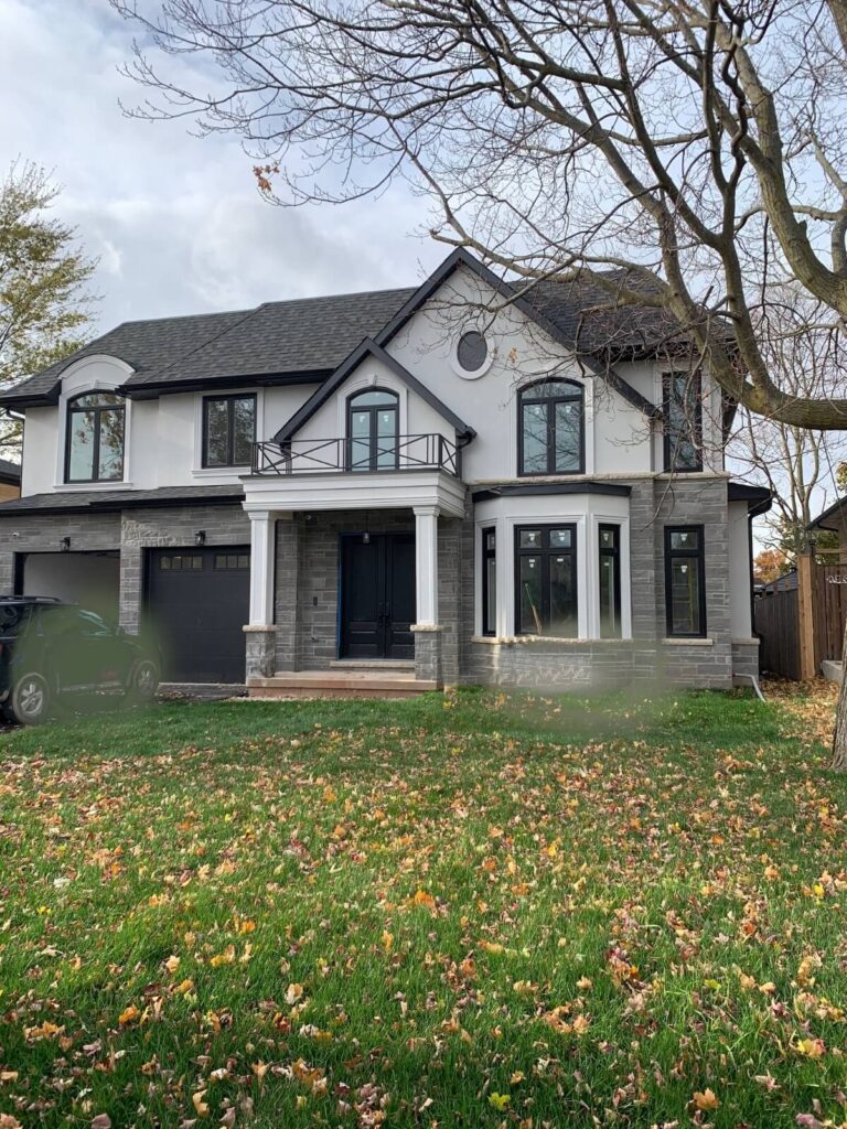 white house with new black vinyl framed windows