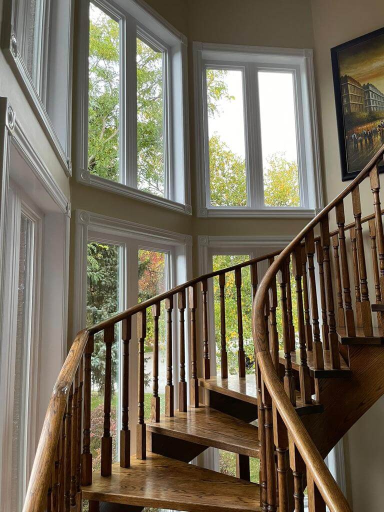 winding staircase with new two storey window installation