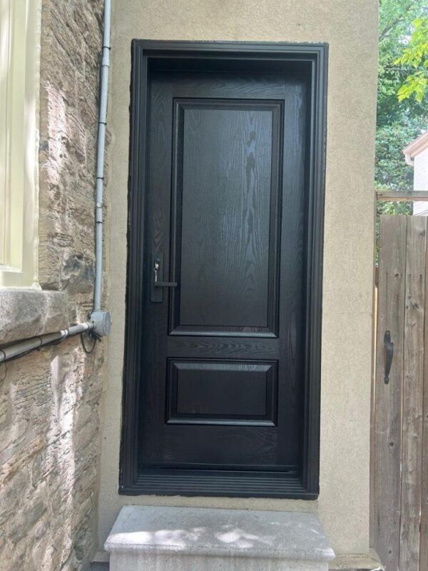 Black fiberglass entry door with wood grain texture