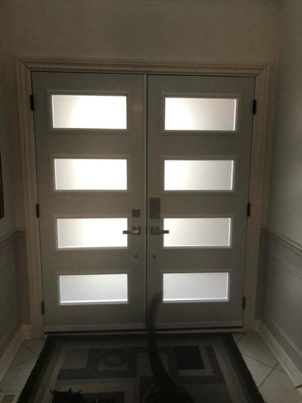 Black steel double entry door with glass inserts and white colour inside