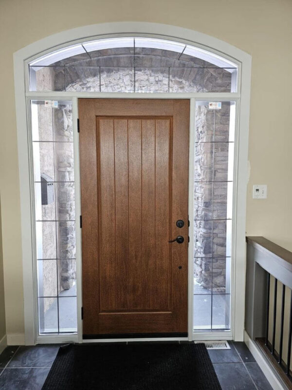 Brown fiberglass entry door with sidelights and transom inside