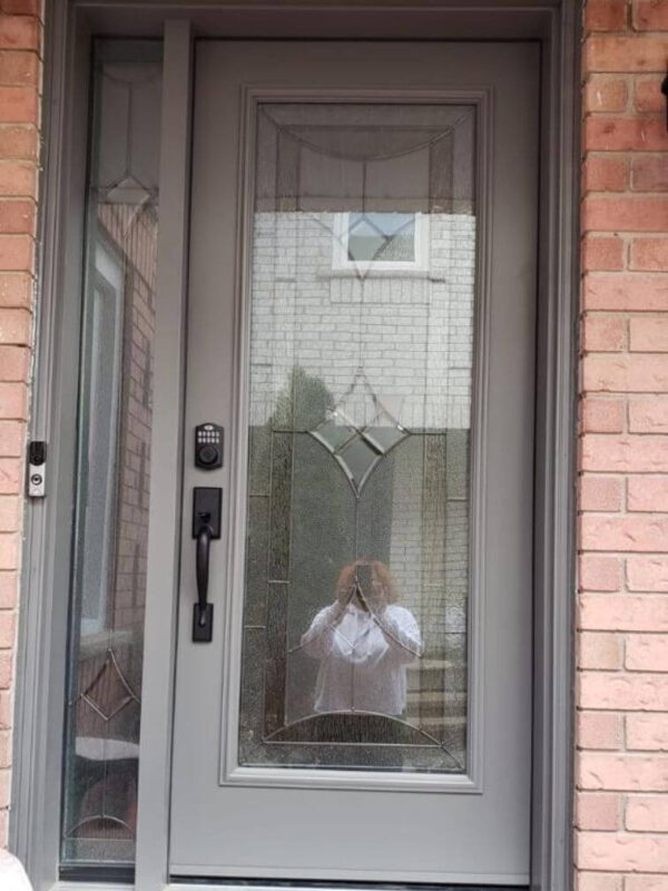 Grey steel entry door with decorative glass insert