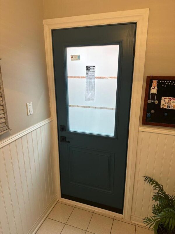 Teal steel entry door with glass insert inside