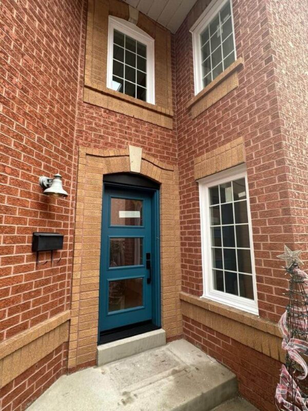 Teal steel entry door with multiple glass inserts