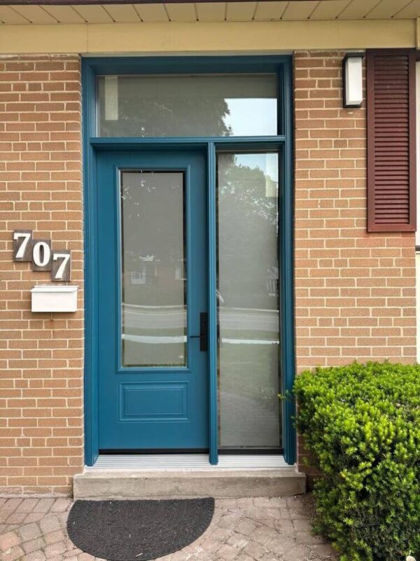 Teal steel entry door with sidelite and transom