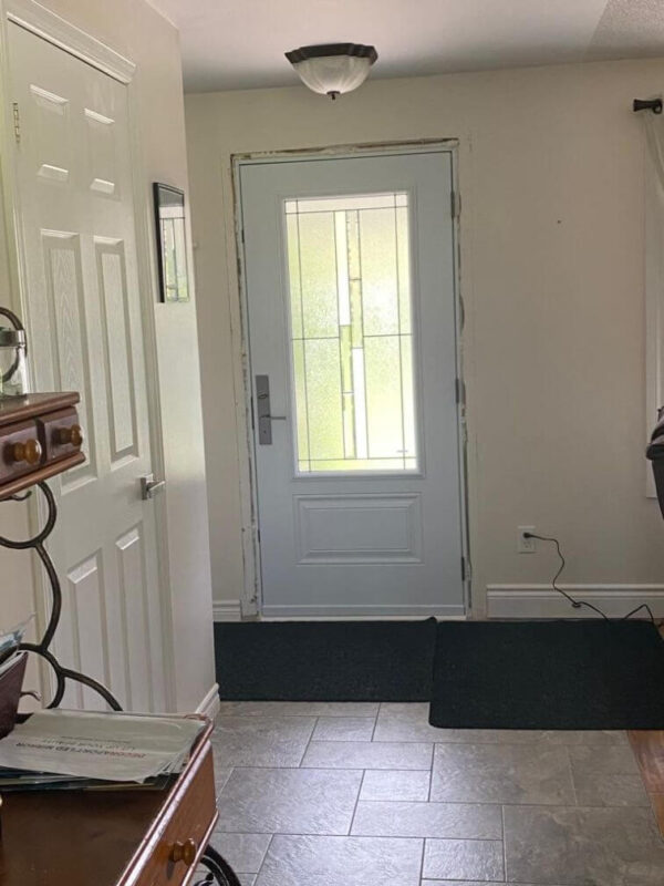 White steel entry door with decorative glass insert inside