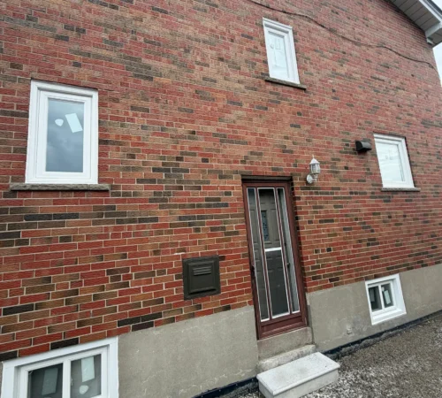 Side elevation of a Toronto brick home after full-frame window replacement