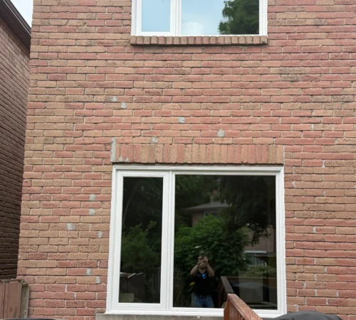 Stacked replacement windows installed on a Mississauga brick wall exterior