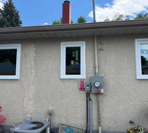Full-Frame Window and Door Replacement Project in Winnipeg, Manitoba - northshield project 18 rear stucco wall window group exterior