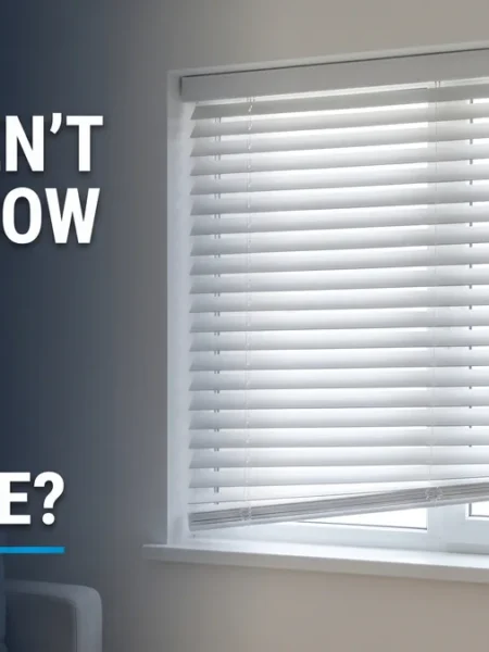 White window blinds hanging slightly crooked, illustrating window blinds not sitting flush