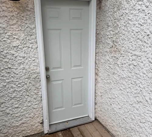 Full-Frame Steel Door Replacement Project in Calgary, Alberta - white side door deck exterior