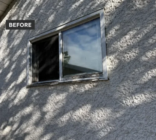 Before replacement: old wood window with visible deterioration