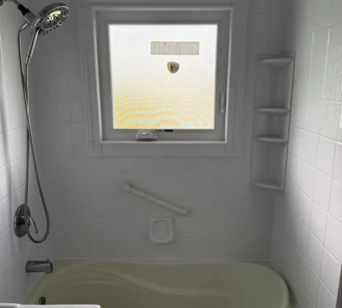Privacy glass awning window installed above a bathtub