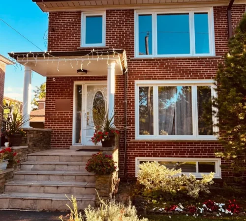 White retrofit windows on the front of a North York brick home